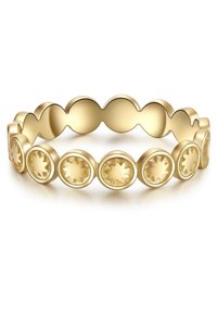 Zlati prstan s valovitim dizajnom in okroglimi detajli, kjer vsak prikazuje vzorec sončnega žarka. Gladka površina s poliranim zaključkom.