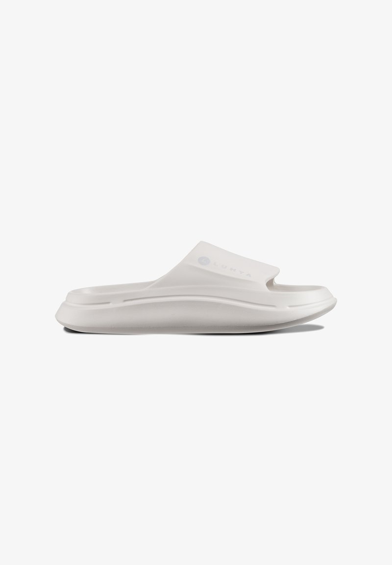 White slide sandal made of flexible material, featuring a smooth texture, cut-out for toes, and a slightly raised sole for comfort.