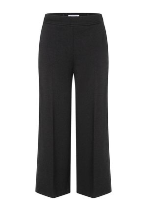 Pantalons noirs à jambes larges avec une taille élastique, fabriqués à partir d'un tissu lisse. Caractéristiques d'un design épuré sans fermetures ni poches visibles.