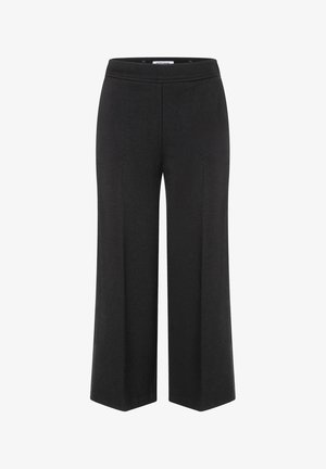 Pantalons noirs à jambes larges avec une taille élastique, fabriqués à partir d'un tissu lisse. Caractéristiques d'un design épuré sans fermetures ni poches visibles.