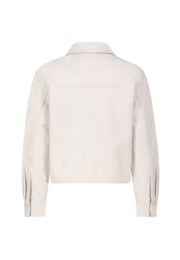 Kort jasje van lichtbeige stof met lange mouwen, knoopmanchetten en een klassieke kraag. Zachte textuur met subtiele stikdetails.