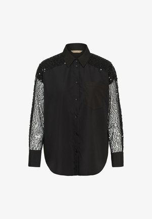 Chemise noire avec un devant uni, dotée de manches transparentes ornées de sequins. Comprend un col à boutons et une poche poitrine.