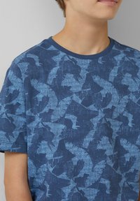 Blauwe katoenen t-shirt met een textuurpatroon in verschillende tinten blauw, met een ronde halslijn en korte mouwen.