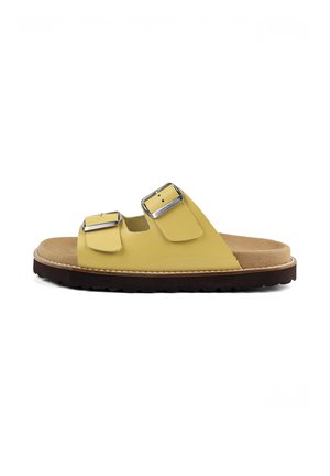 Yellow open-toe slide sandal with two adjustable silver buckled straps and a brown cushioned sole with black tread.
