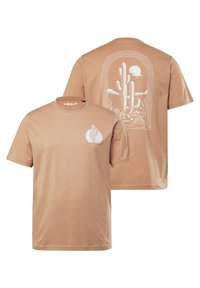 Béžové bavlněné tričko s bílým designem kaktusu na zadní straně a menším logem na přední straně. Krátké rukávy, kulatý výstřih.