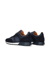 Navy sneakers with a mix of smooth leather and suede, featuring a rubber sole and brown inner lining. Low-top design with minimal accents.