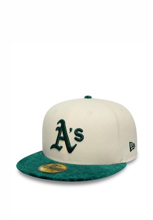 Beige and green baseball cap with curved brim featuring dark green "A's" logo and New Era emblem on the side.