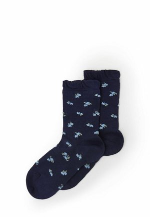 Marineblaue Socken mit einem gerippten Bündchen, die ein verstreutes Blumenmuster in Hellblau und Grün aufweisen. Aus einem weichen, elastischen Material gefertigt.
