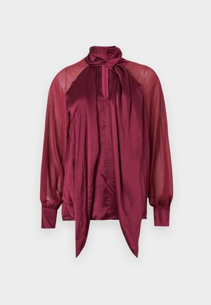 Long-sleeve burgundy blouse with sheer sleeves, satin front, high neckline, and a tied bow detail at the collar.