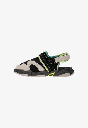 Black and gray athletic sandal with a suede and textile upper, green accents, adjustable strap, and textured rubber sole.