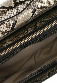 Snake print clutch bag with a glossy texture, featuring a gold zipper and black accents. The interior is lined with a smooth neutral fabric.
