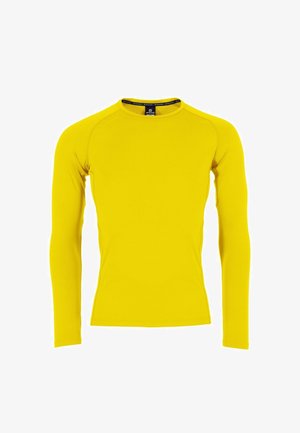 Chemise à manches longues de couleur jaune vif, fabriquée en tissu extensible. Présente un col rond et une coupe ajustée avec une texture lisse.