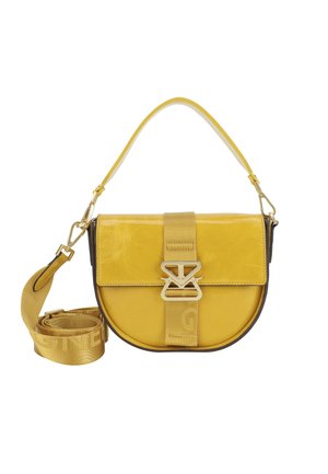 Yellow leather crossbody bag with a round shape, adjustable strap, gold hardware, and a prominent strap closure across the front.