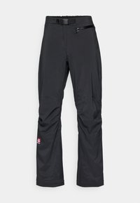 Pantalones impermeables negros con cinturón, que cuentan con un bolsillo con cremallera en el muslo derecho y un parche con el logo cerca del dobladillo, fabricados en tejido texturizado.