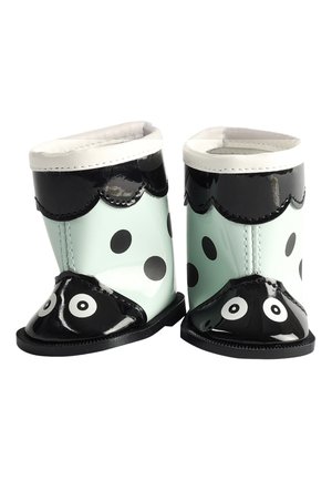 Bottes de pluie pour tout-petits avec des pois noirs et blancs, une bordure noire festonnée et des yeux imprimés sur les orteils.