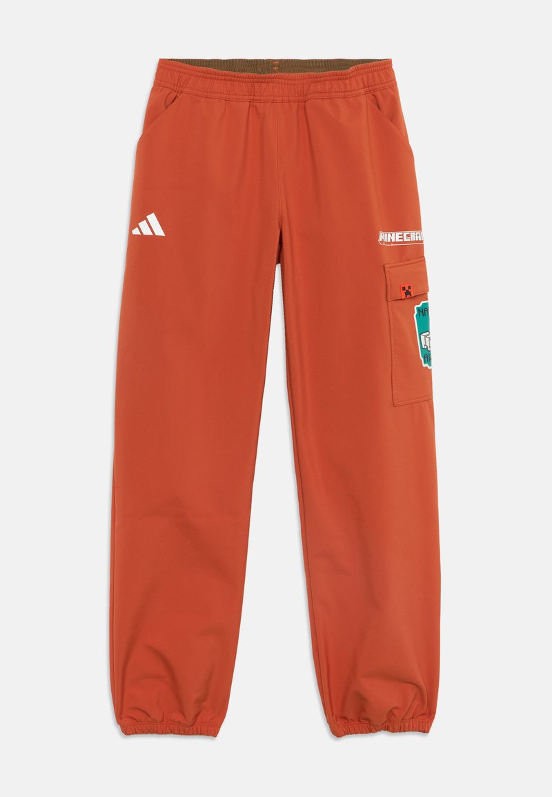 Πορτοκαλί παντελόνια Adidas με ελαστική μέση και μανσέτες, λογότυπο Minecraft και γραφικά χαρακτήρων στην δεξιά τσέπη cargo και στο μηρό.