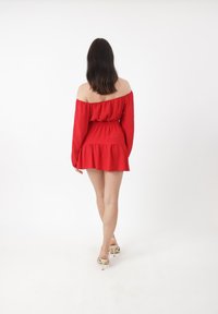 Rotes schulterfreies Kleid mit langen Ärmeln, tailliertem Schnitt und ausgestellt Rock. Glatter Stoff mit gerafften Details an der Taille und dem Saum.