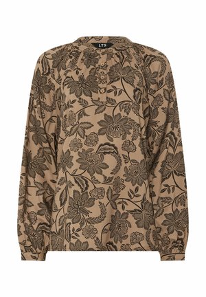 Chemisier beige à manches longues avec des motifs floraux noirs complexes et une patte de boutonnage partielle à l'avant.