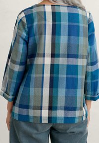 Plaid top featuring a mix of blue and green tones, lightweight textured fabric, 3/4 sleeves, and a square neckline.