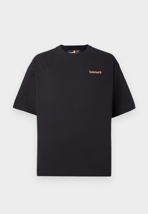 Black short-sleeve crew neck Timberland T-shirt with small tan logo on the upper left chest, displayed on a white background.