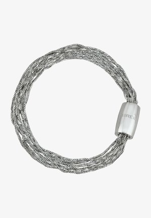 Srebrna bransoletka z wieloma nitkami, wykonana z plecionego metalu. Posiada gładki cylindryczny zamek z grawerunkiem "BREIL". Teksturowane nici tworzą głębię.