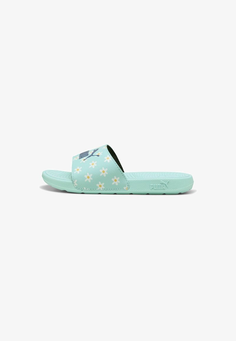 Light mint green slide sandal with floral pattern, flat sole, and textured footbed. Puma logo on side. Made from flexible material.