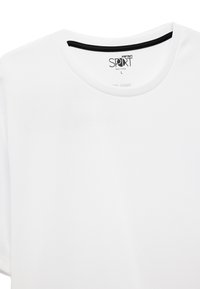 Hvid kortærmet atletisk T-shirt med sort krave, lavet af tekstureret stof. Mærket siger "Koton SPORT," størrelse L, fremstillet i Tyrkiet.