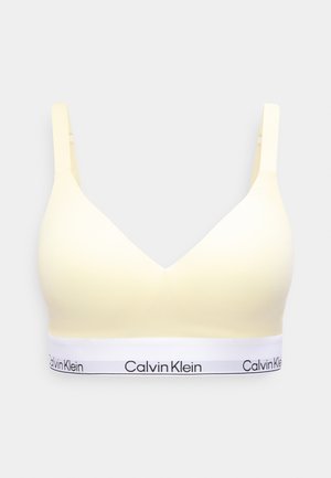 Sutien wireless galben moale cu bretele reglabile și bandă elastică albă cu logo-ul negru Calvin Klein.