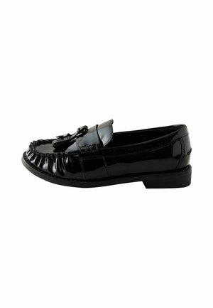 Black shiny leather loafer with tassels, stitched front, and low heel shown from side on white background.