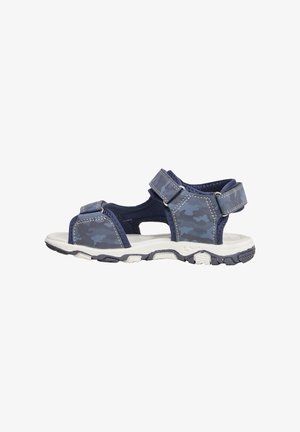 Infradito blu navy con cinghie camouflage, chiusure regolabili in velcro e suola in gomma bianca con motivi testurizzati per una migliore aderenza.