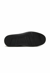 Suola di sneaker nera in gomma testurizzata, con un motivo a tasselli per trazione e stabilità. Sezioni curve e piatte per il comfort.
