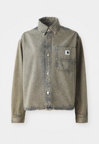 Denim shirt in faded light brown with a front pocket, silver snap buttons, and a collared neckline. Textured fabric with subtle variations.