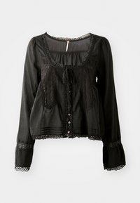 Blusa nera a maniche lunghe con bordo in pizzo sul collo, sui polsini e sulla parte anteriore, dotata di bottoni e un fiocco annodato sul petto.