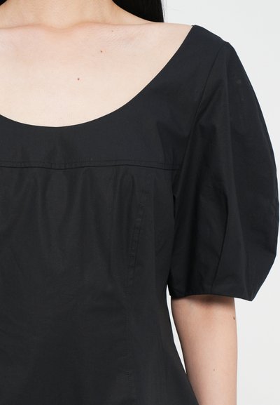 Black dress with a wide scoop neckline, short puff sleeves, and smooth texture. Features a fitted bodice and a subtle vertical seam detail.