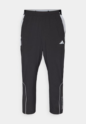 Fekete sportnadrág elasztikus derékbőséggel, szürke oldalhúzásokkal, fehér fényvisszaverő részletekkel és "Climacool" felirattal az alsó lábszáron.