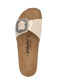 Beige patent slide sandal with a wide strap and a decorative silver-tone buckle. Cushioned brown insole with brand logo. Flat profile.