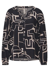 Blusa a maniche lunghe in bianco e nero con motivi geometrici astratti, chiusura frontale con bottoni e maniche arricciate per texture e dettagli.