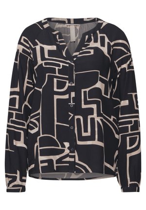 Blusa a maniche lunghe in bianco e nero con motivi geometrici astratti, chiusura frontale con bottoni e maniche arricciate per texture e dettagli.