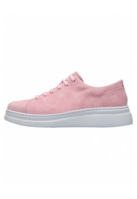 Pink suede sneaker with white rubber sole, rounded toe, and six eyelet lace-up design. Features a smooth texture and simple silhouette.