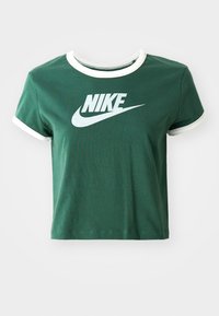 Grön bomullströja med vit rundad krage och ärmslut. Har en stor vit Nike-logotyp över bröstet. Kortad design.