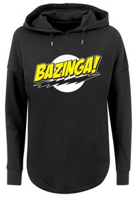 Fekete kapucnis pulóver, melyen egy kerek, fehér grafika található, rajta a "BAZINGA!" szó dőlt, sárga betűkkel, alatta villám motívumokkal. Hosszú ujjú, laza szabású.