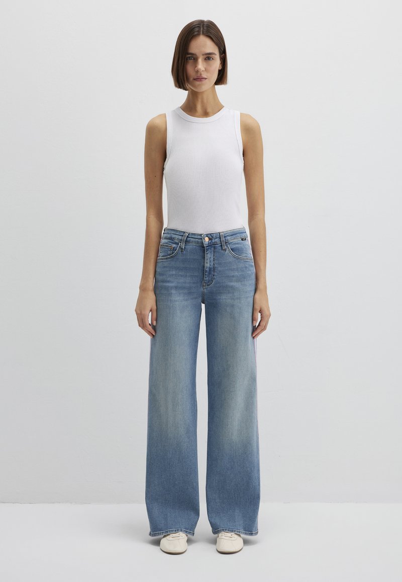 Wide-leg blue denim jeans paired with a fitted white sleeveless top. The jeans feature a high waist and classic five-pocket design.