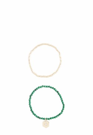 Gold-colored bead bracelet with rectangular links above a green beaded bracelet featuring a hexagonal charm. Both are elastic.