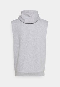 Sweat à capuche sans manches gris vu de dos, présentant une capuche et une texture douce, sur fond blanc uni.