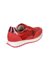 Red sneaker features a mix of textured materials, metallic accents, mesh detailing, and a white sole with pink trimming.