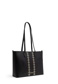 Svart syntetisk tote bag med lange håndtak, med gullfargede øyeblikk i vertikale linjer på forsiden og en jevn tekstur.