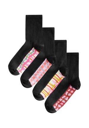 Four pairs of black socks featuring assorted colorful patterns on the foot, including stripes and geometric designs, with contrasting toe colors.