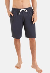 Shorts de bain bleu marine avec une taille élastique, fermeture à cordon de serrage et poches latérales, présentant une texture de tissu lisse.