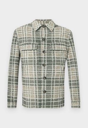 Kockás flaneling zöld, krémszínű és bézs színekben. Gombos záródás, két elülső zseb és gallér jellemzi. Puha tapintású, hosszú ujjú.