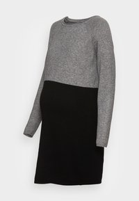 Abito premaman con una parte superiore grigia e una parte inferiore nera, realizzato in morbido materiale a maglia, con maniche lunghe e scollatura rotonda.